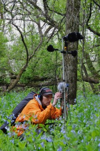 sound artist Paul Dickinson recording in woods
