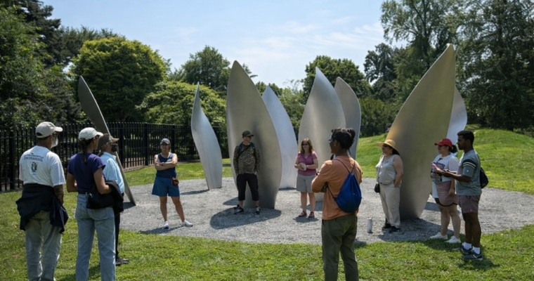 People gathering in the park amidst sculptures